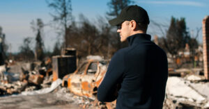 A man visiting the scene of a disaster