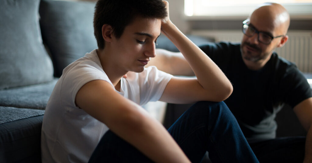 Upset young man talking with his father.