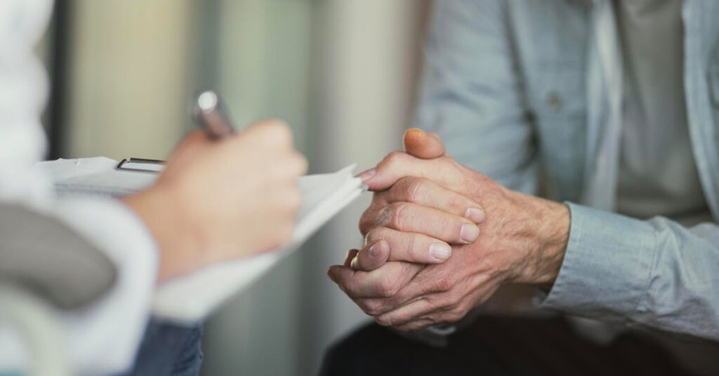 Doctor talks with patient and takes notes