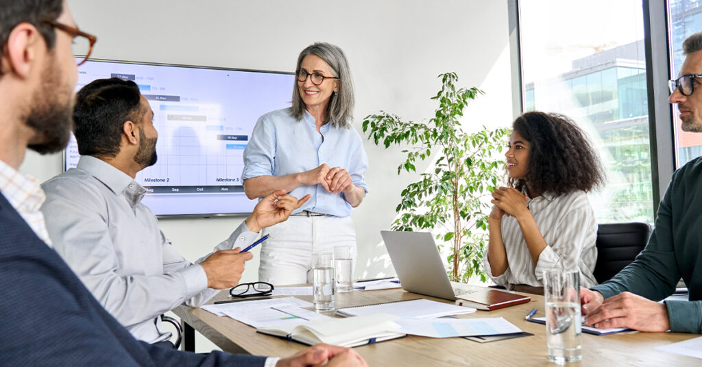 executive team people having board meeting discussing project results. Diverse employees group working with senior leader brainstorming in office meeting room at presentation training