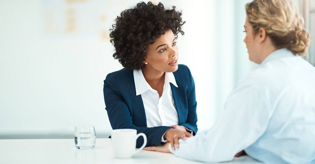 Shot of two businesspeople having a discussion in a modern office