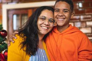 Two family members hugging and diffusing family Conflict and the Holidays