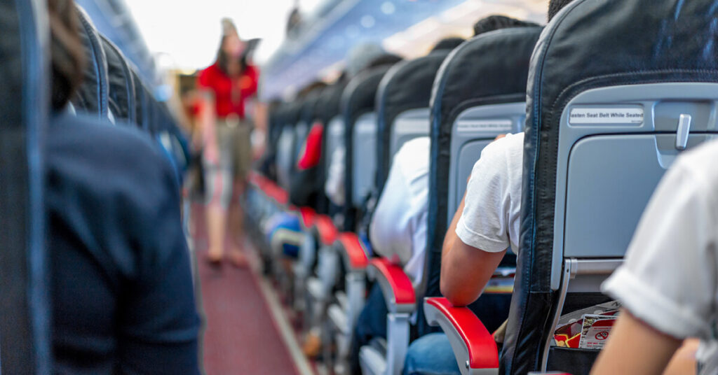 A group of travelers seated in an airplane